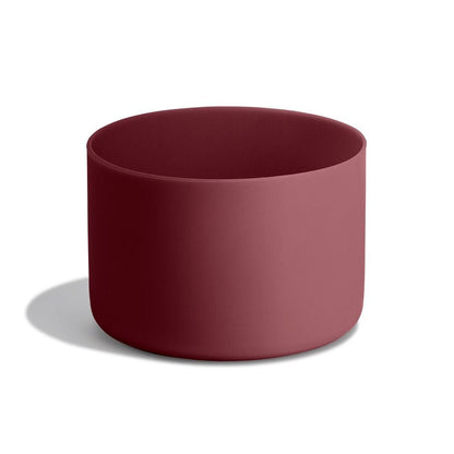 Deep burgundy Hydro Flask cylindrical container with matte finish, smooth unadorned sides, and rounded rim. Minimalist design on a light gray surface.