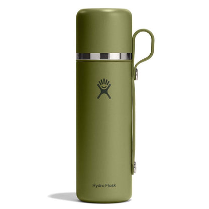 Olive-green Hydro Flask thermos with smooth matte finish, silver metallic band near top, matching side handle, and Hydro Flask logo. Sleek cylindrical design.