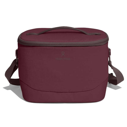 Maroon Hydro Flask insulated soft cooler with oval shape, zippered lid, short top handle, adjustable shoulder strap, and gray trim around zipper and handle.